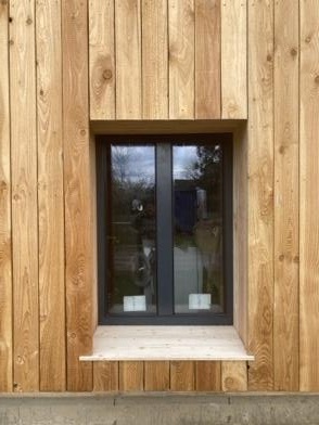 Détail d'une fenêtre intégrée dans un bardage bois